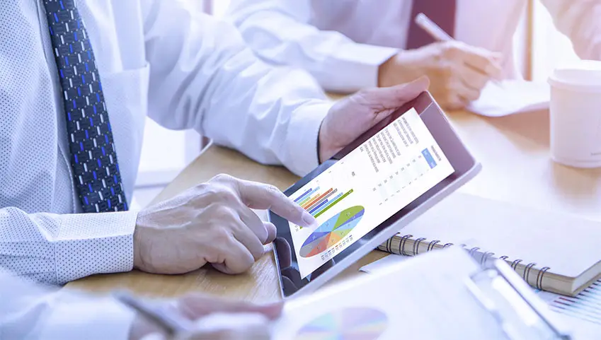 Financial adviser pointing at computer tablet screen with his finger