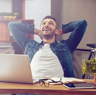 Man tilting backIn chair at desk