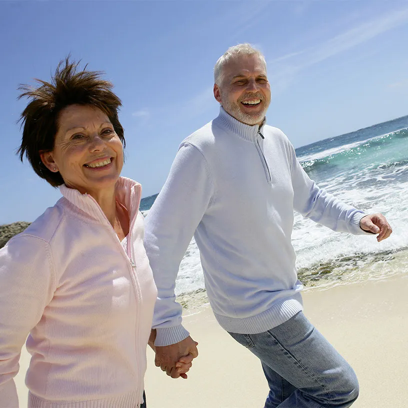 Seniors running on beach