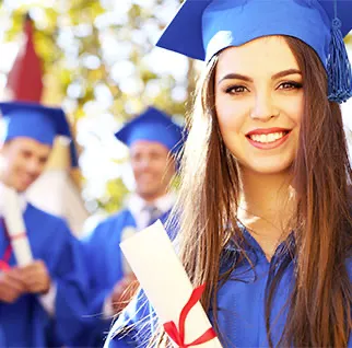 Brunette girl in blue graduation gown holding a college graduation certificate